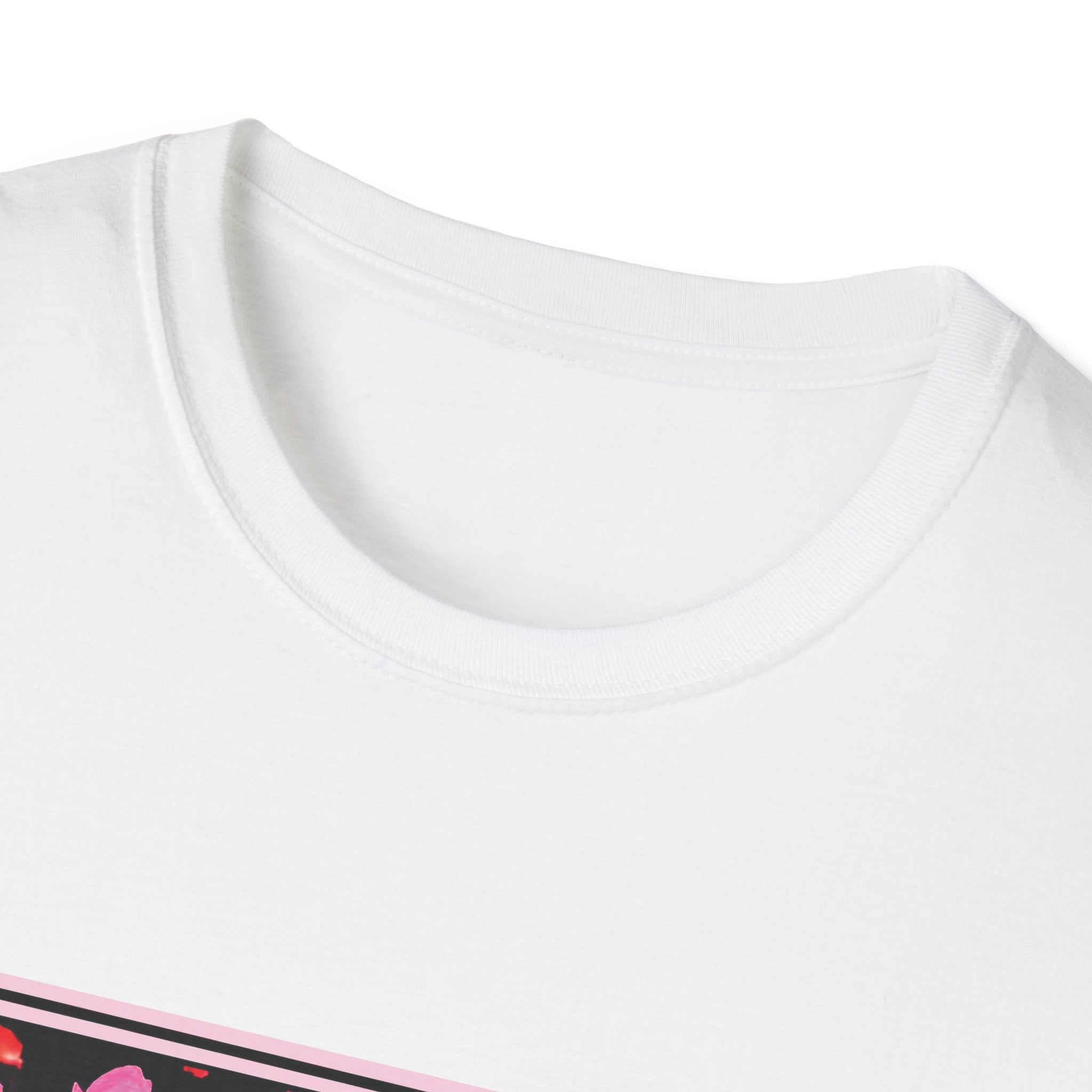 Close-up of a white t-shirt with a small pink and black design at the bottom.